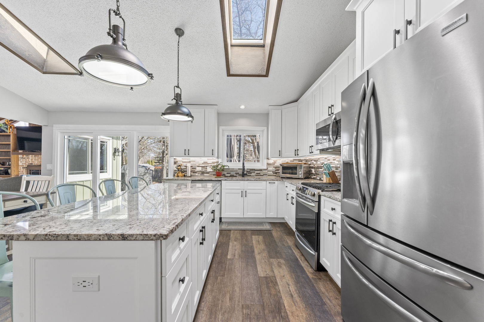 619 West End Road Roselle, IL 60172 - Photo 14 of 37 a kitchen with stainless steel appliances granite countertop hardwood floor sink stove and refrigerator