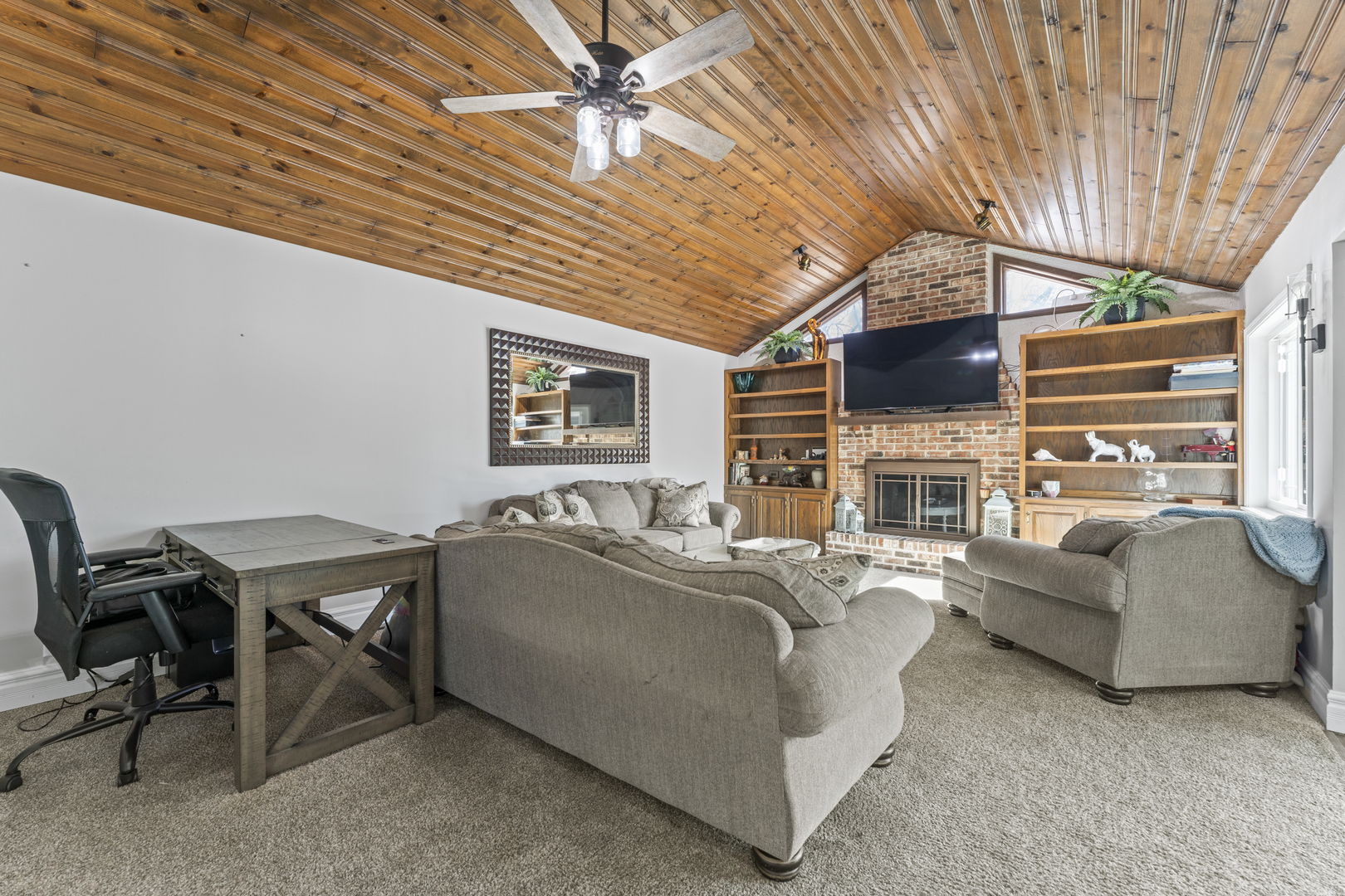 619 West End Road Roselle, IL 60172 - Photo 16 of 37 a living room with furniture a fireplace and a flat screen tv