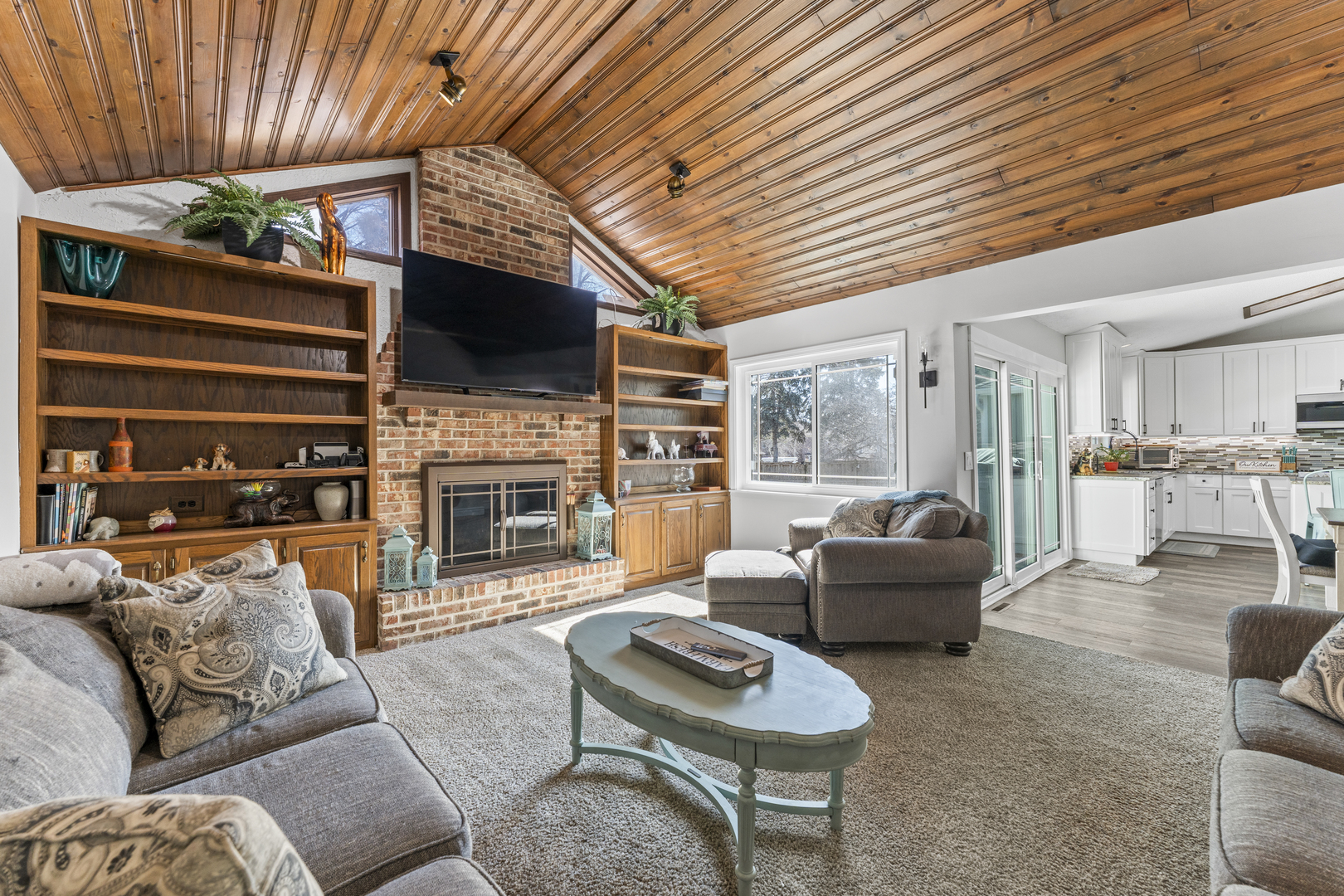 619 West End Road Roselle, IL 60172 - Photo 17 of 37 a living room with furniture a flat screen tv and a fireplace