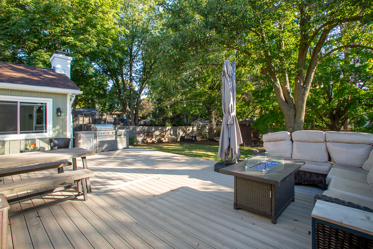 619 West End Road Roselle, IL 60172 - Photo 5 of 37 a view of a patio with couches table and chairs and wooden floor