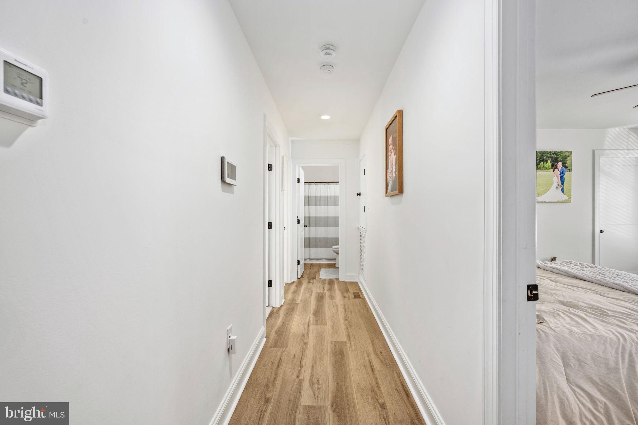 5712 Buckner Road Bumpass, VA 23024 - Photo 21 of 59 a view of a hallway with wooden floor and staircase