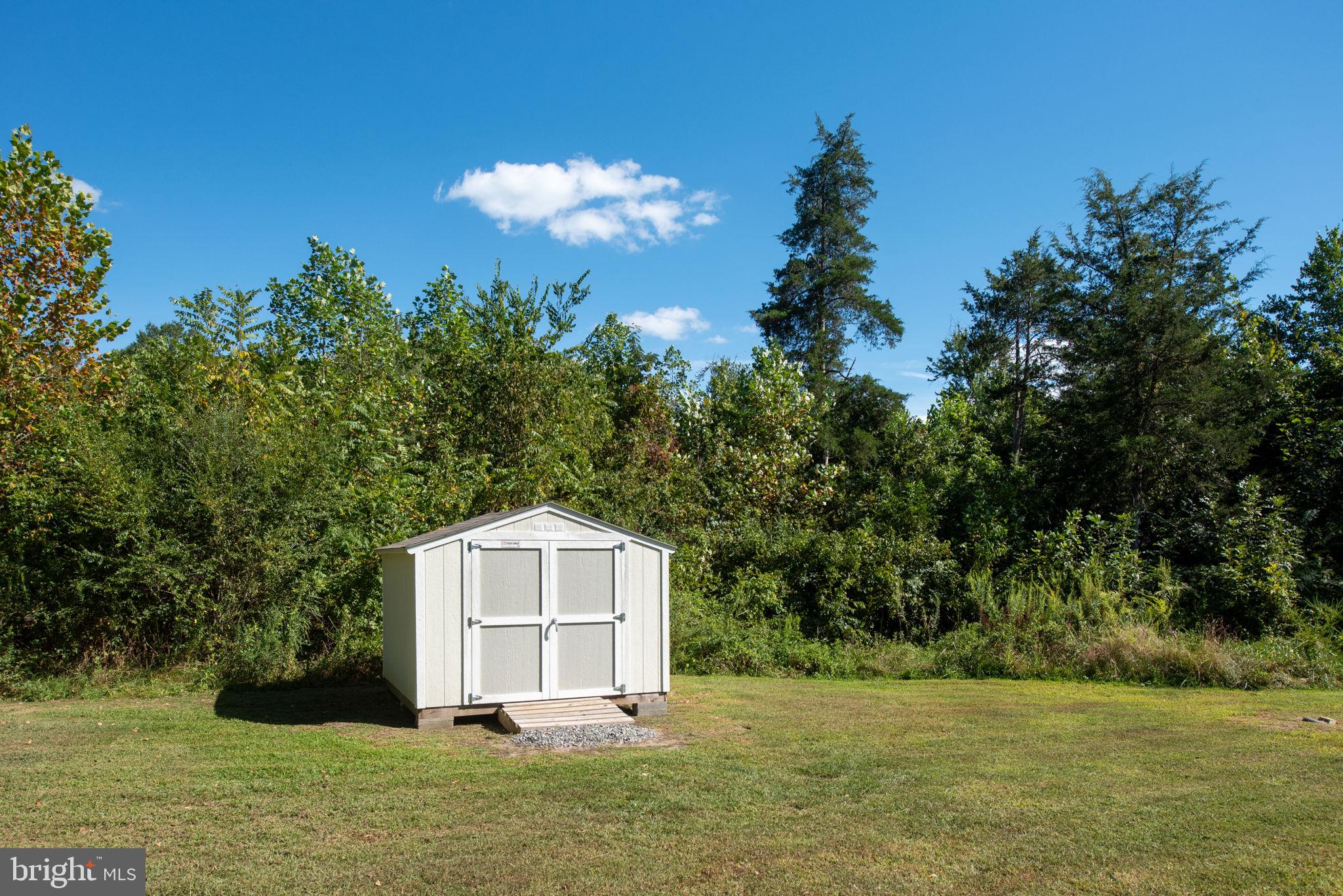 5712 Buckner Road Bumpass, VA 23024 - Photo 34 of 59 a view of a tiny house with a yard