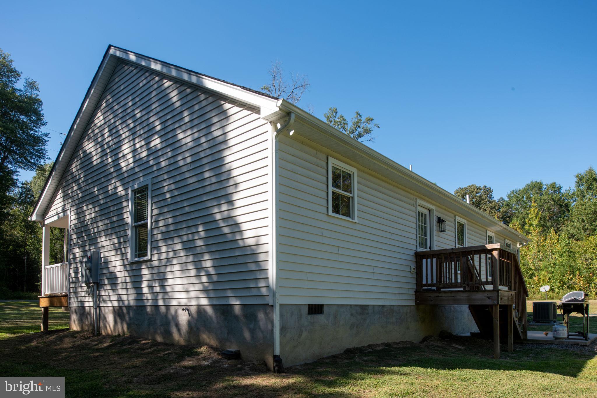 5712 Buckner Road Bumpass, VA 23024 - Photo 38 of 59 a view of house with backyard and trees