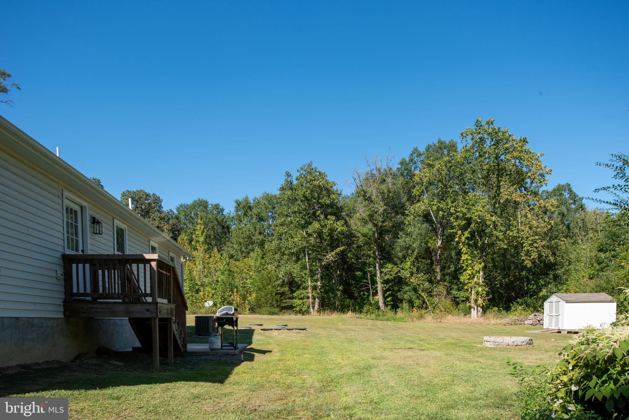 5712 Buckner Road Bumpass, VA 23024 - Photo 39 of 59 a backyard of a house with table and chairs