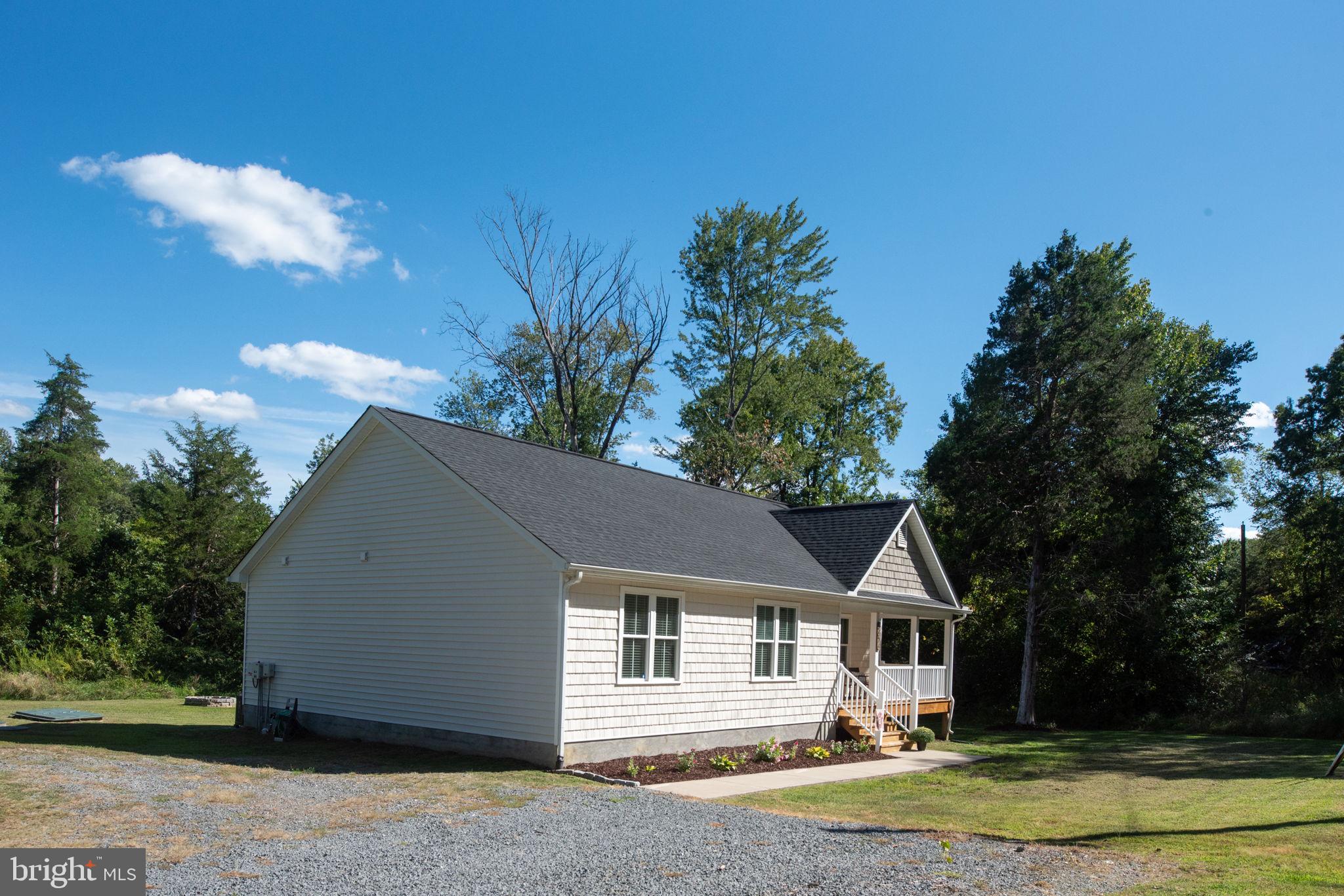 5712 Buckner Road Bumpass, VA 23024 - Photo 41 of 59 a front view of a house with a yard and trees