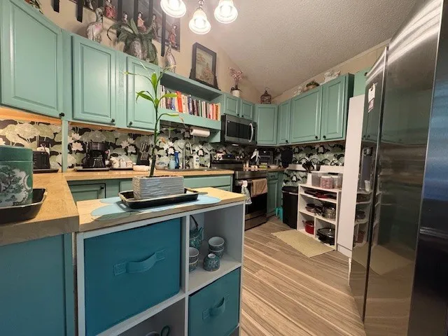 a kitchen with a stove and a refrigerator