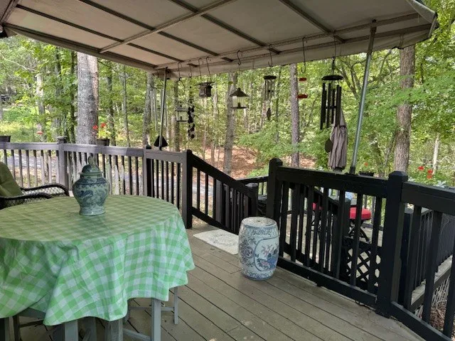 a view of deck with furniture and a yard