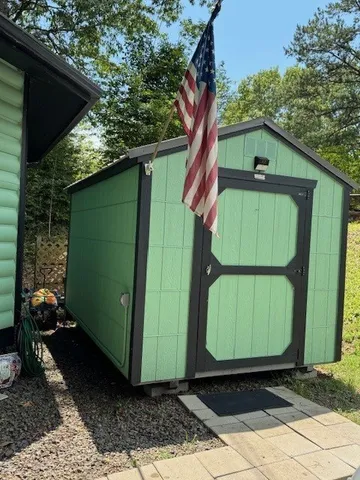 a green field with trees in the background