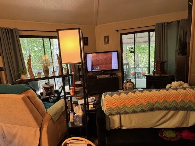 a bedroom with furniture and a flat screen tv