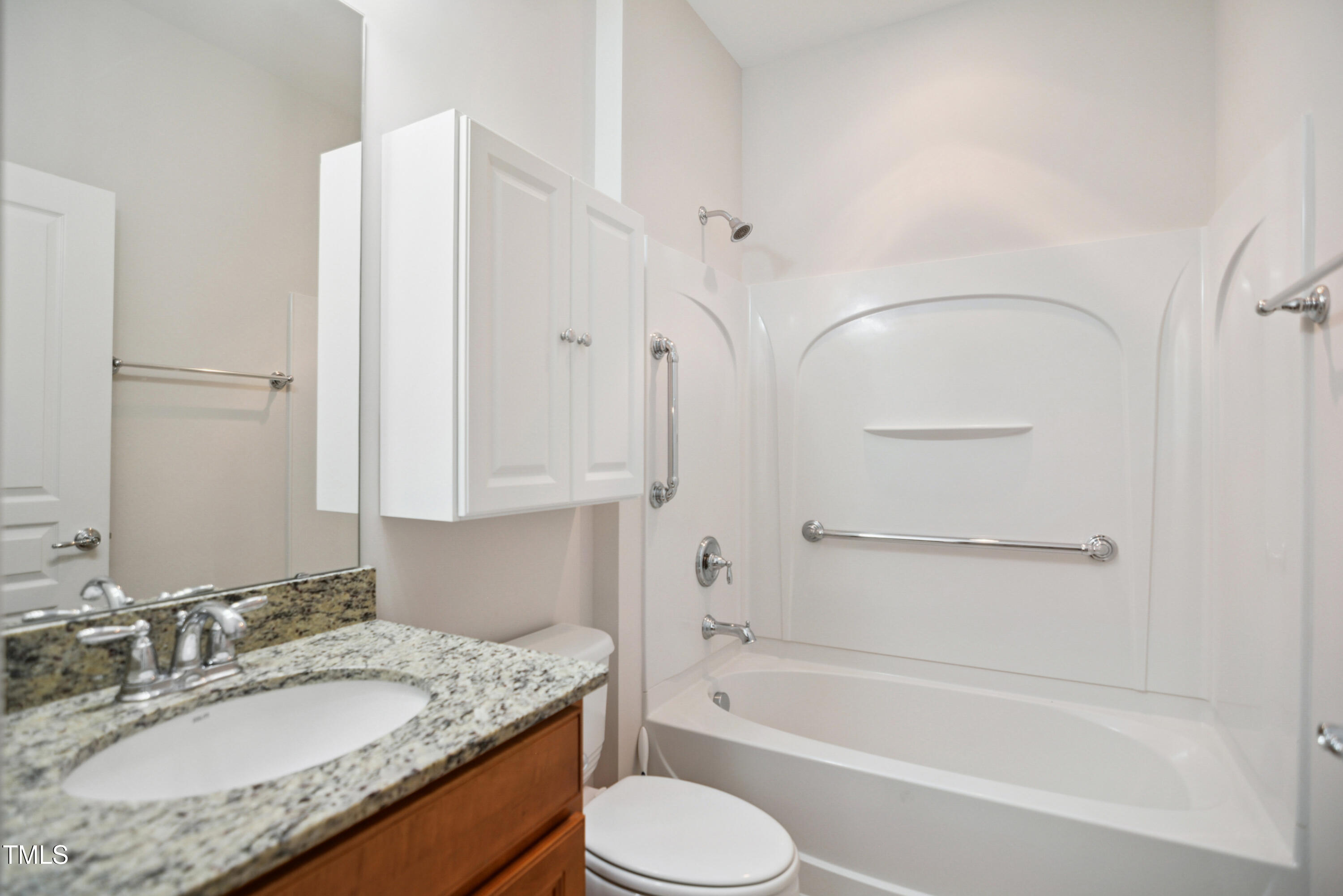 563 Tomkins Loop Cary, NC 27519 - Photo 19 of 26 a bathroom with a granite countertop tub sink toilet and mirror