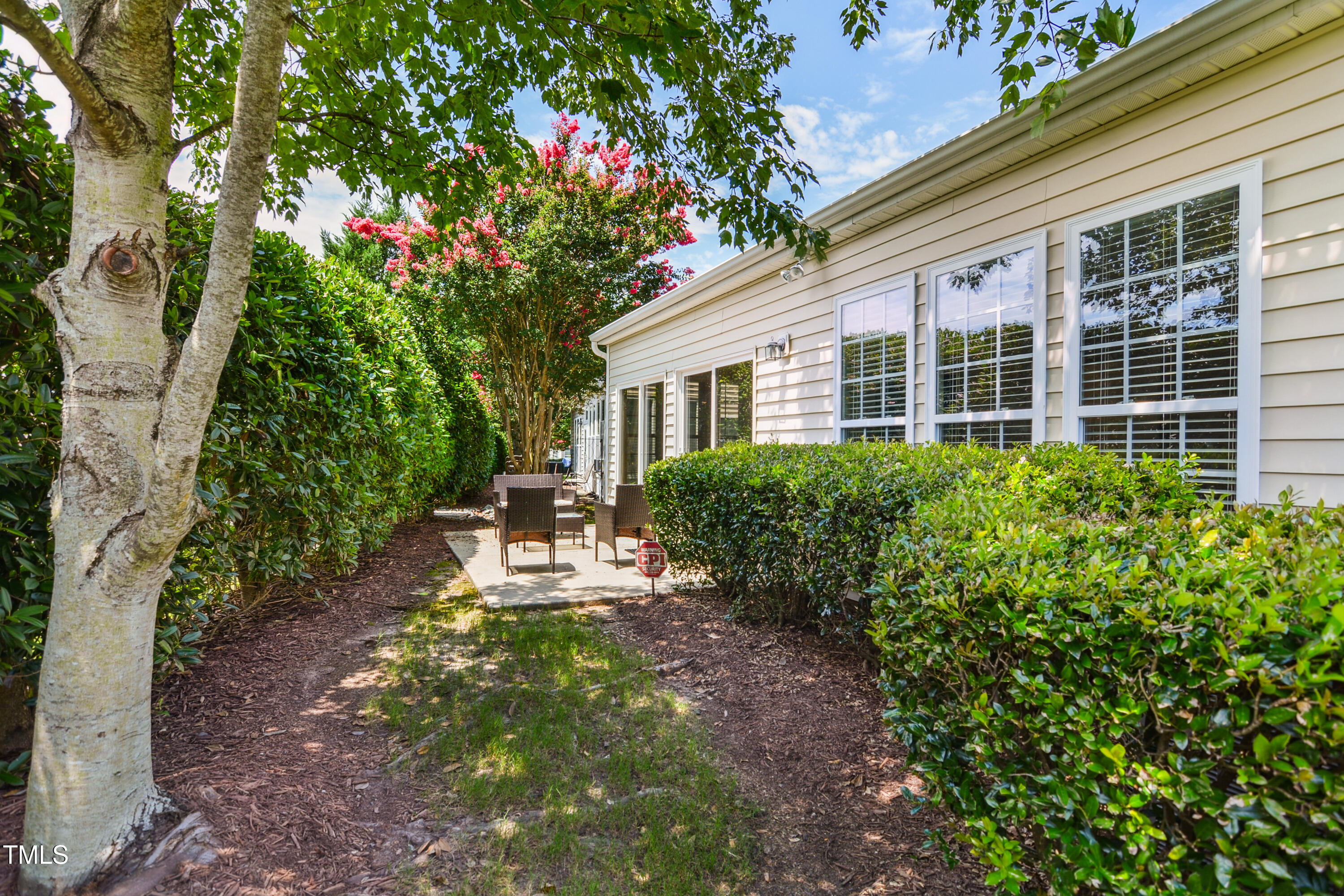 563 Tomkins Loop Cary, NC 27519 - Photo 21 of 26 a view of a house with sitting area and garden