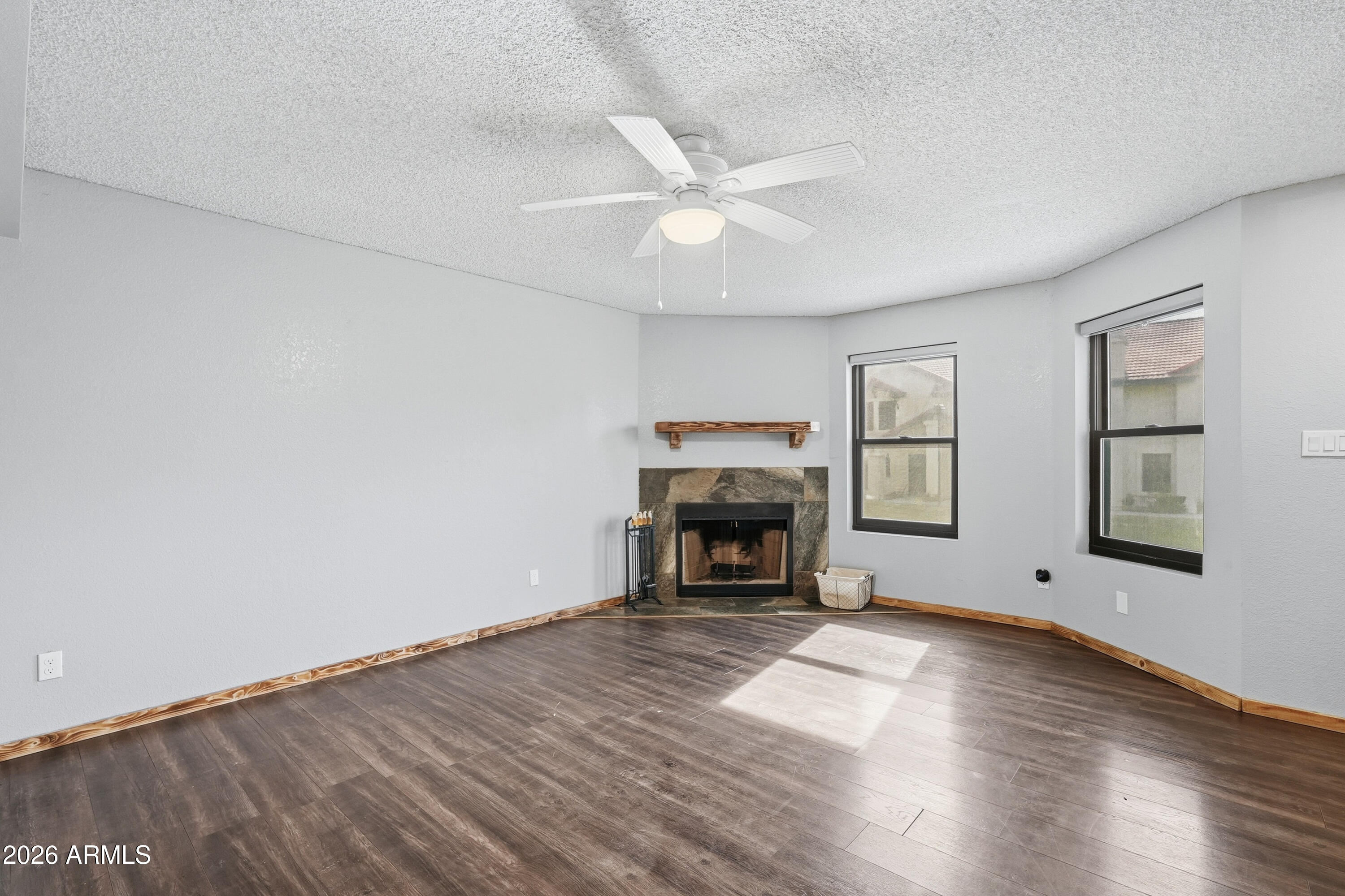 6262 East Brown Road, Unit 10 Mesa, AZ 85205 - Photo 13 of 33 a view of empty room with wooden floor and fireplace