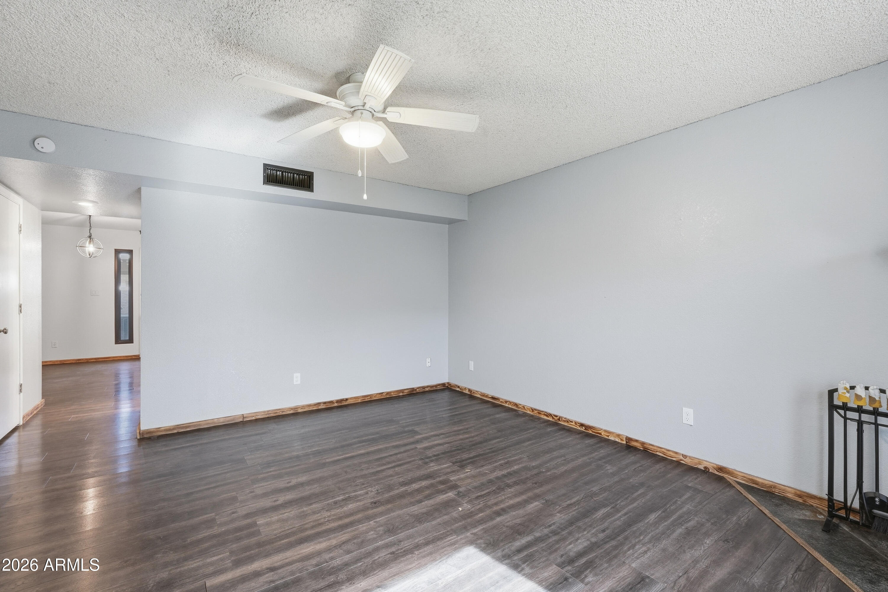 6262 East Brown Road, Unit 10 Mesa, AZ 85205 - Photo 15 of 33 a view of an empty room with wooden floor
