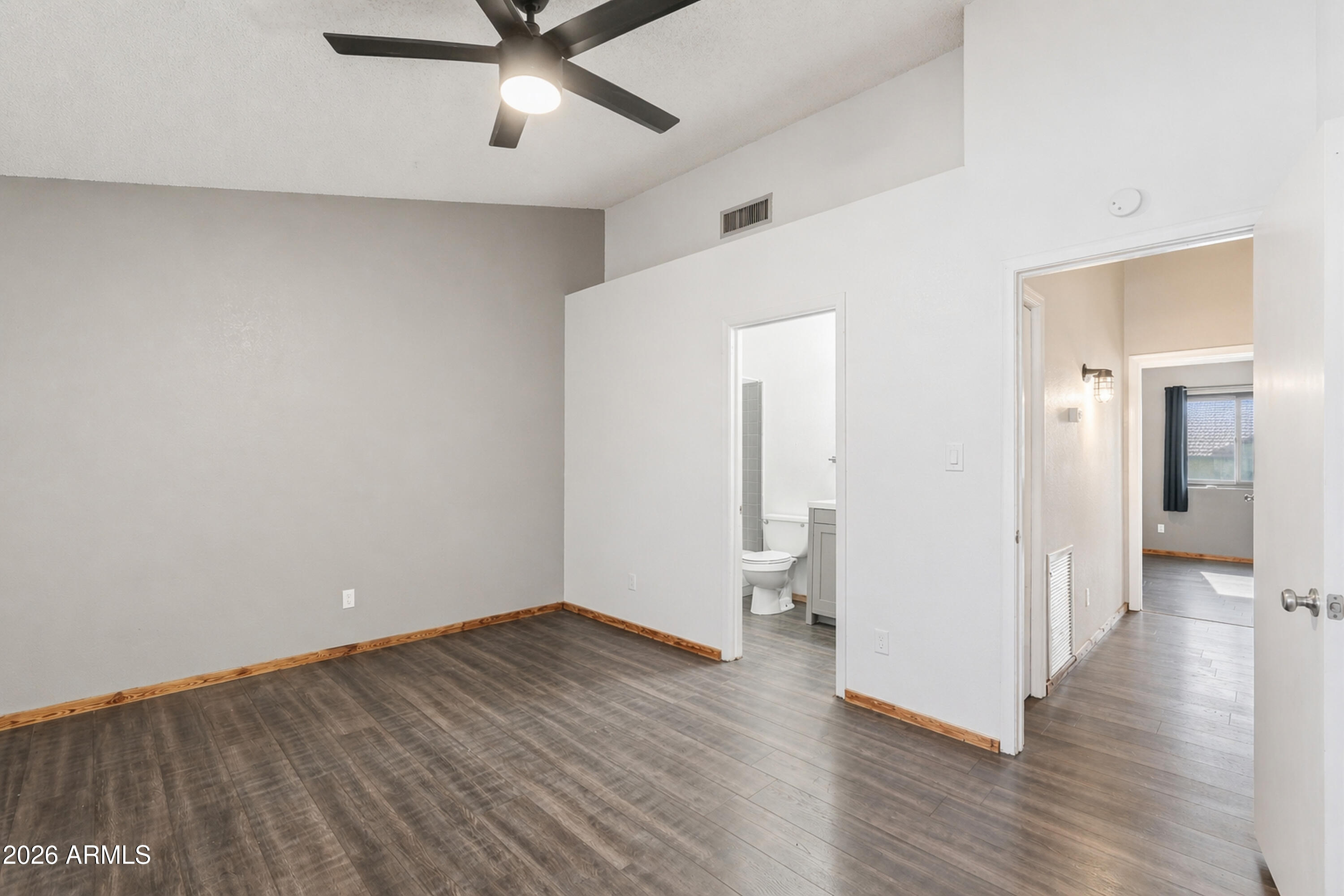 6262 East Brown Road, Unit 10 Mesa, AZ 85205 - Photo 18 of 33 a view of a room with wooden floor and white walls
