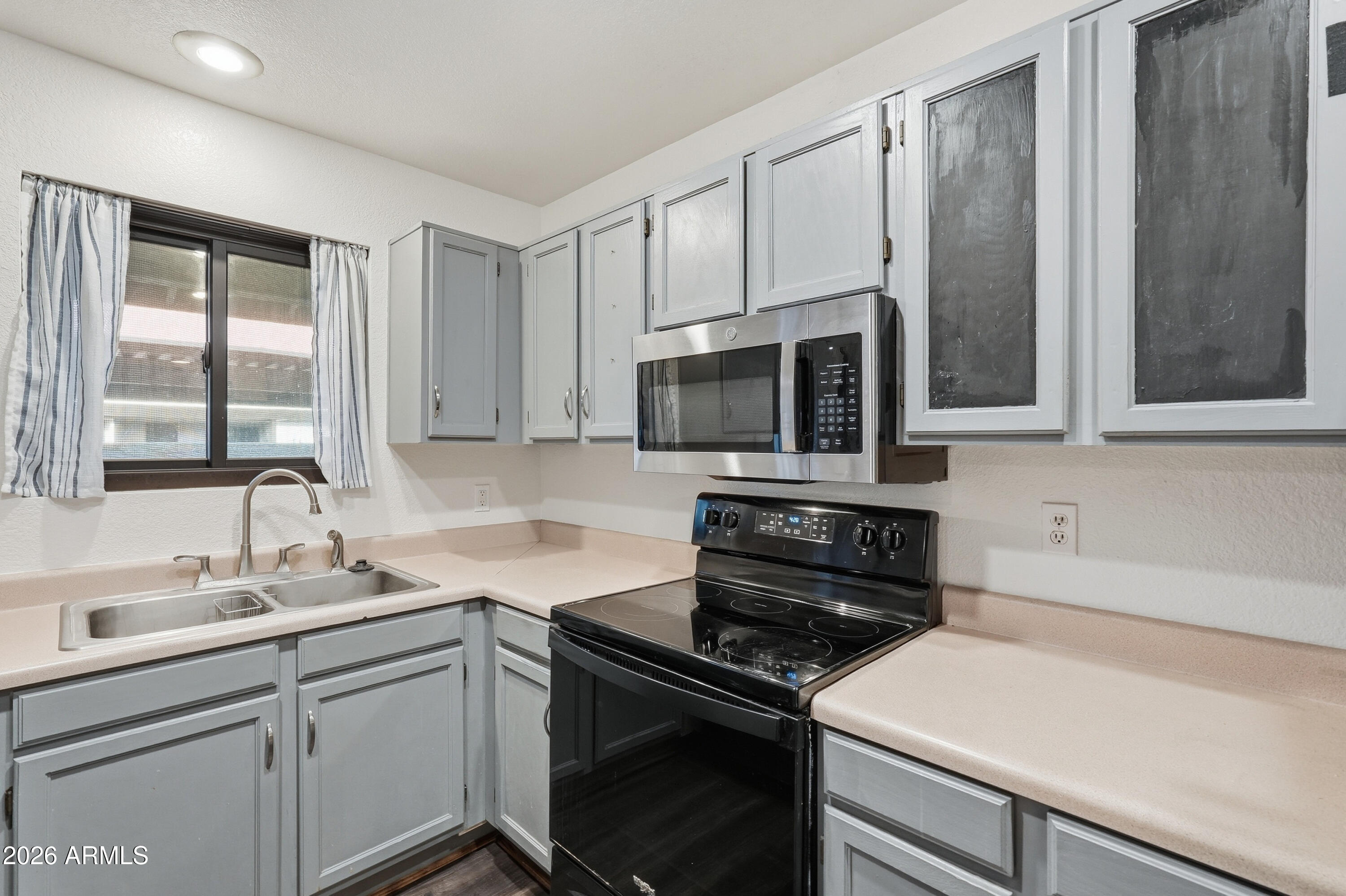 6262 East Brown Road, Unit 10 Mesa, AZ 85205 - Photo 2 of 33 a kitchen with a sink stove and microwave