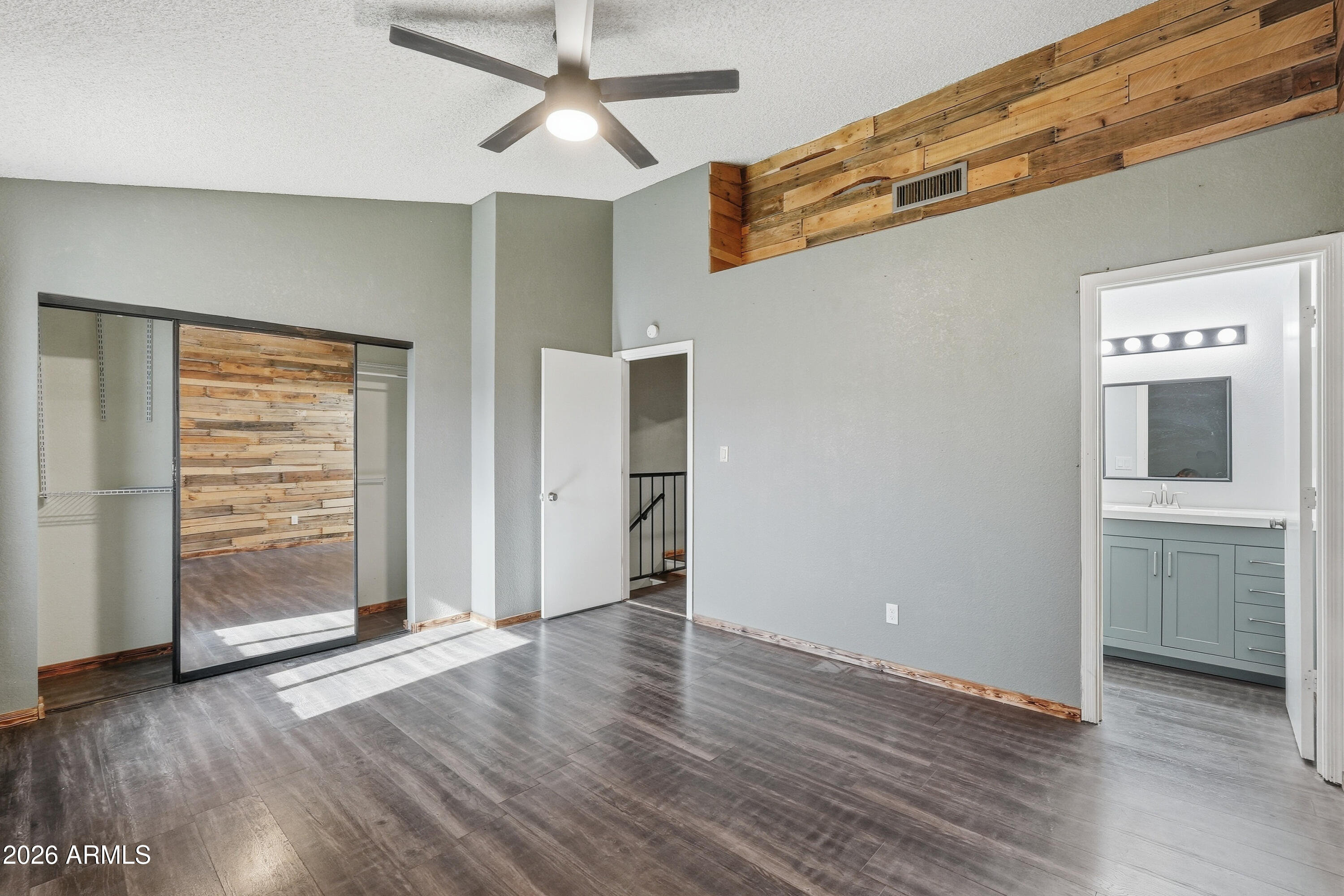 6262 East Brown Road, Unit 10 Mesa, AZ 85205 - Photo 22 of 33 an empty room with wooden floor cabinet and windows