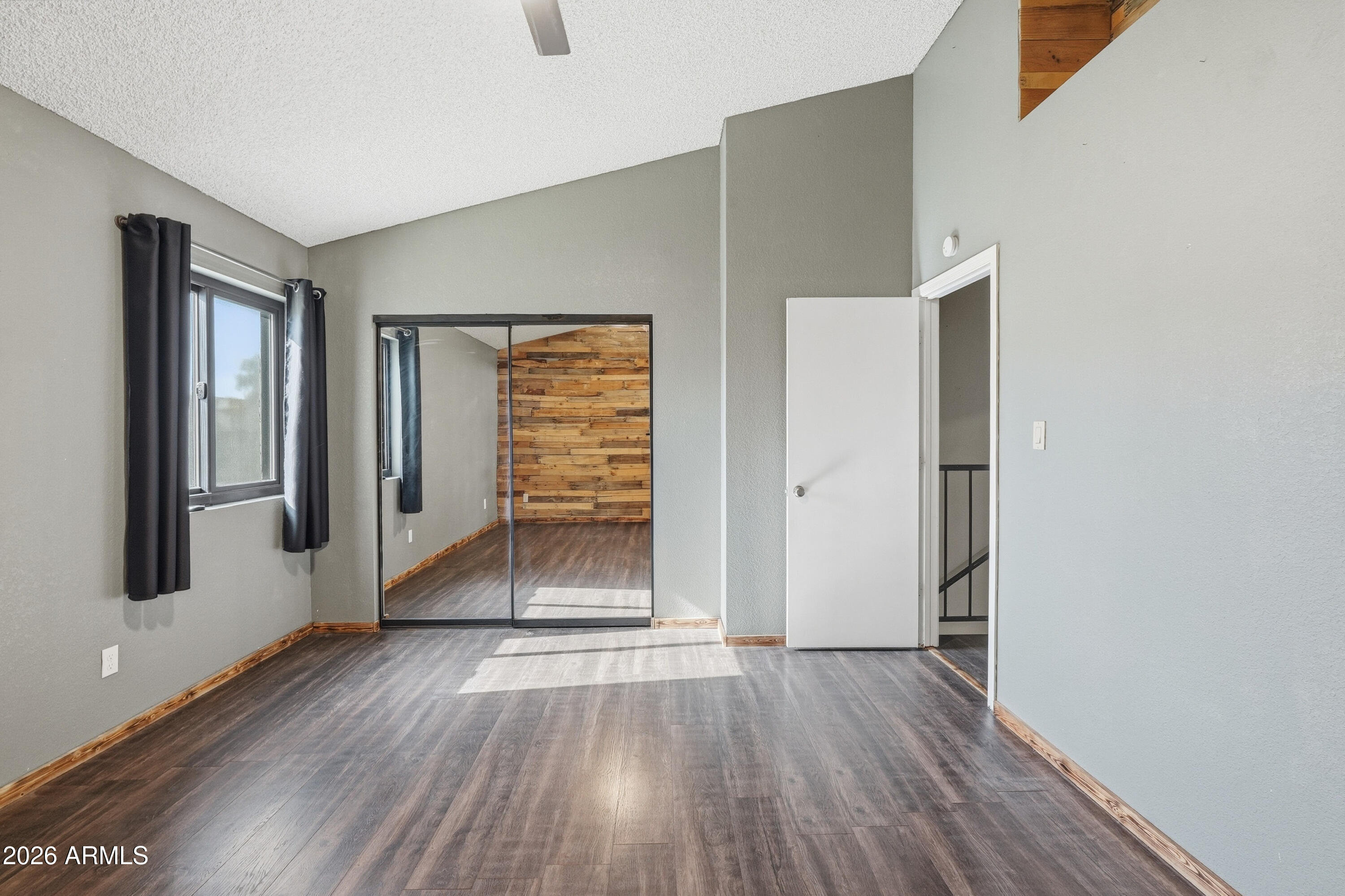 6262 East Brown Road, Unit 10 Mesa, AZ 85205 - Photo 24 of 33 an empty room with wooden floor and windows
