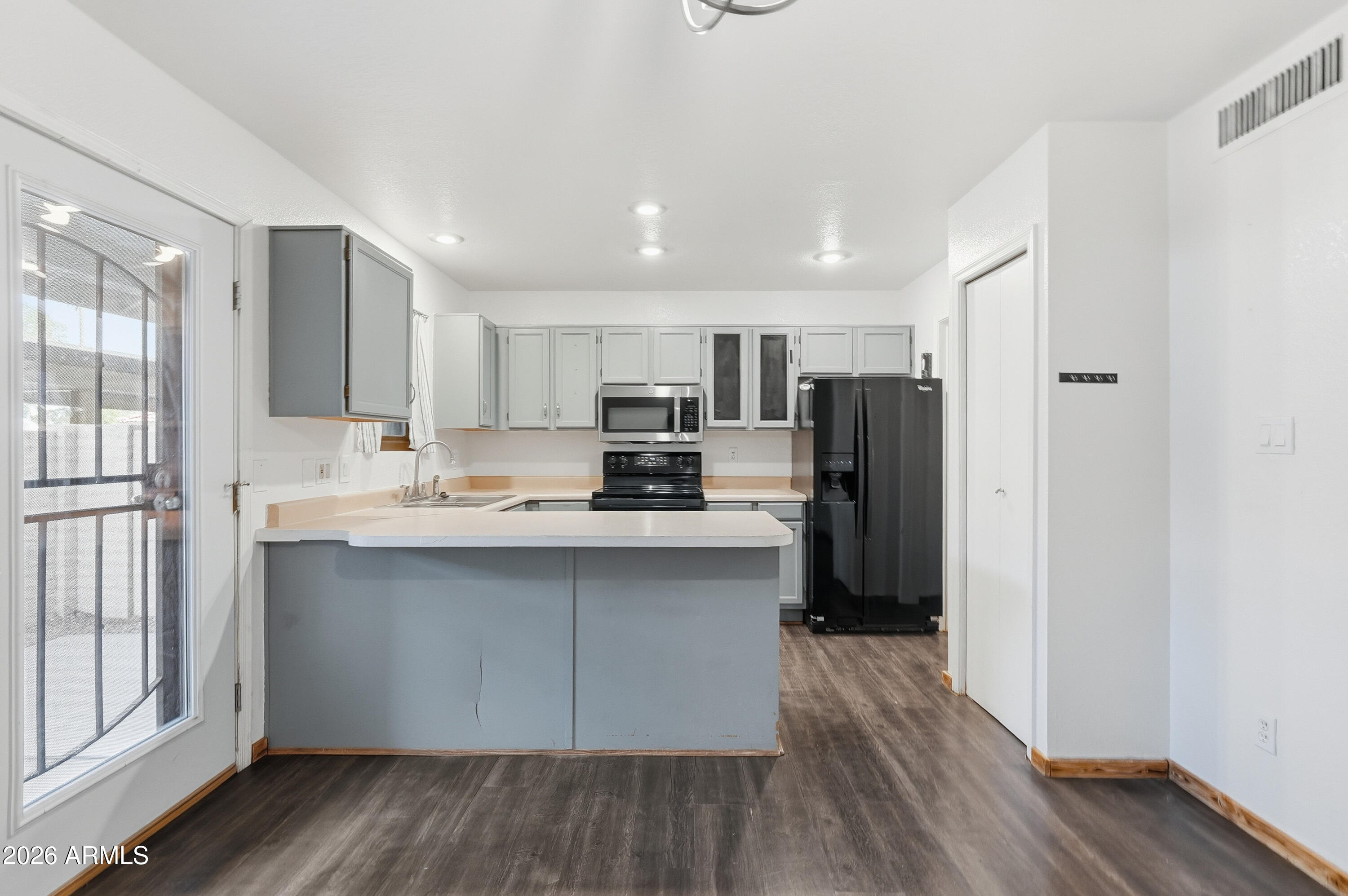 6262 East Brown Road, Unit 10 Mesa, AZ 85205 - Photo 3 of 33 a kitchen with stainless steel appliances a refrigerator sink and microwave