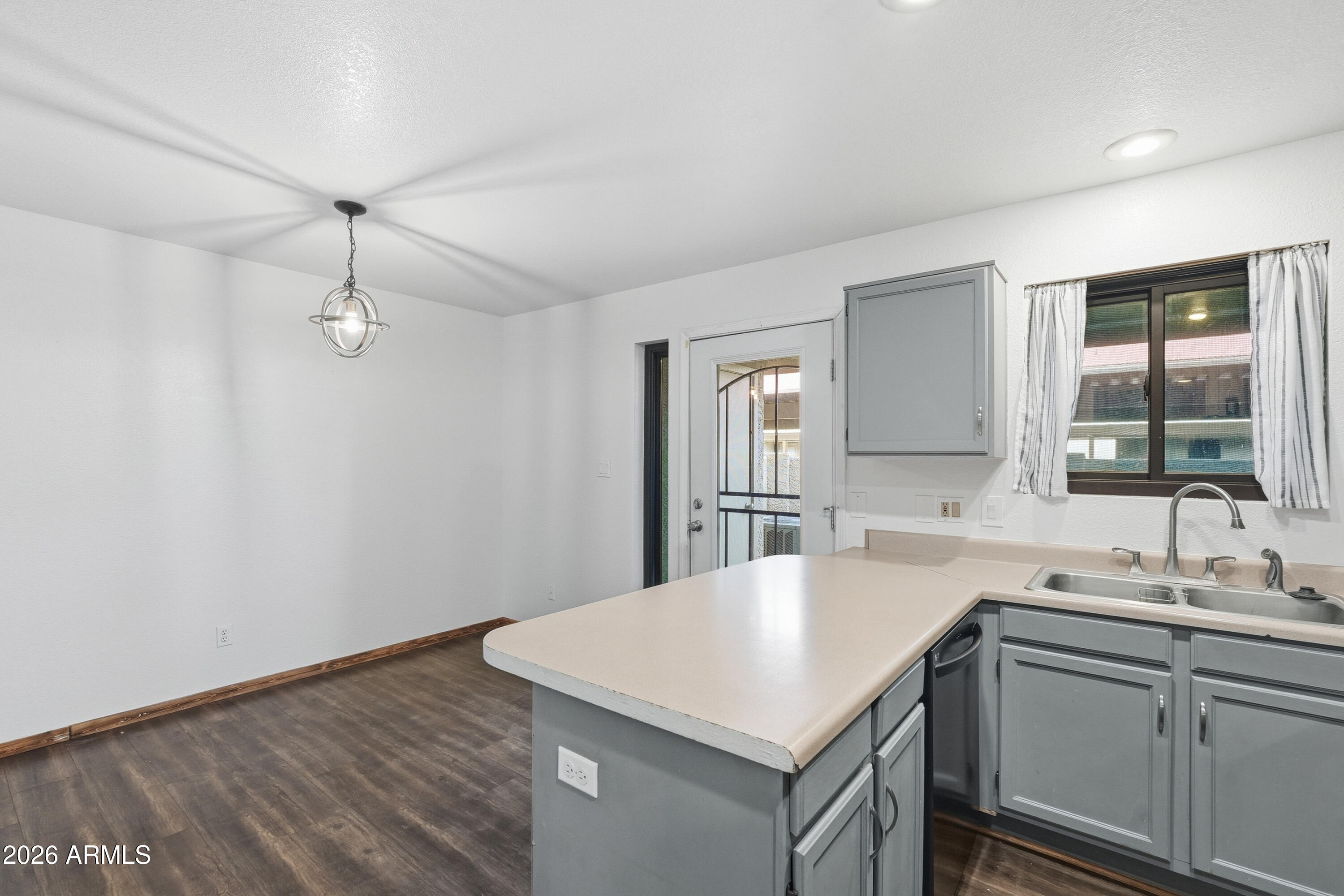 6262 East Brown Road, Unit 10 Mesa, AZ 85205 - Photo 4 of 33 a kitchen with a sink a counter space and appliances
