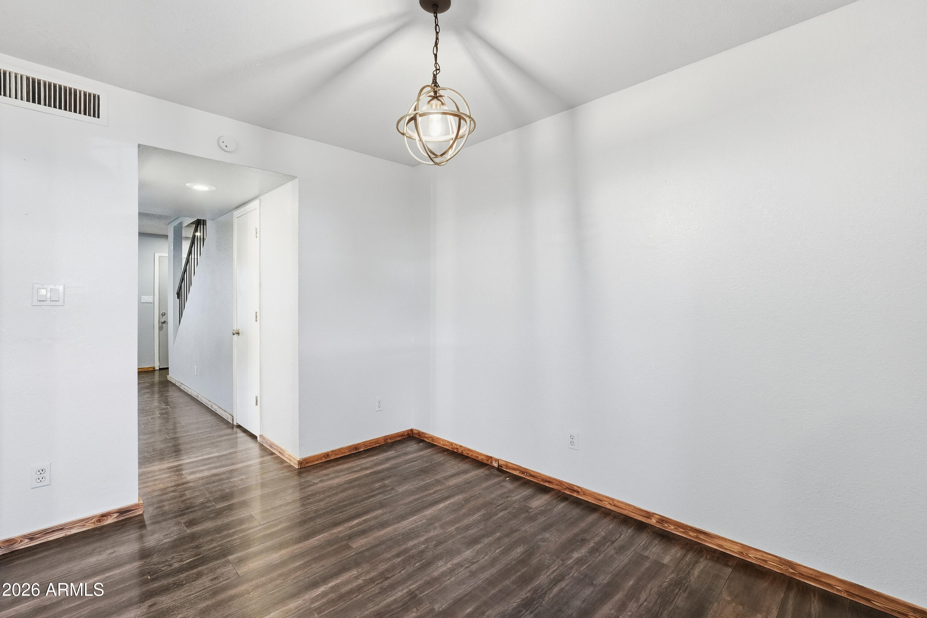 6262 East Brown Road, Unit 10 Mesa, AZ 85205 - Photo 9 of 33 a view of a hallway with wooden floor and a chandelier