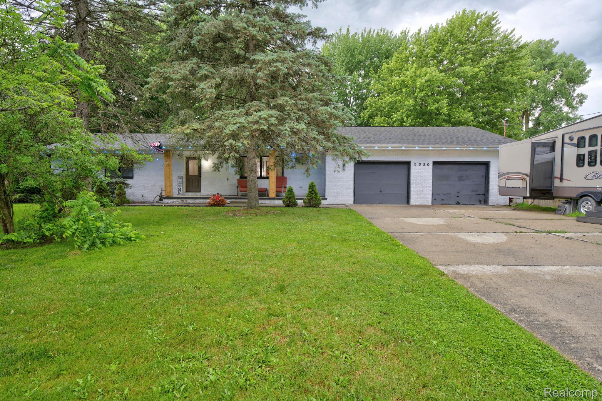 5330 Sheridan Road Saginaw, MI 48601 - Photo 4 of 50 Single-story residence featuring a white brick facade and a multi-vehicle concrete driveway