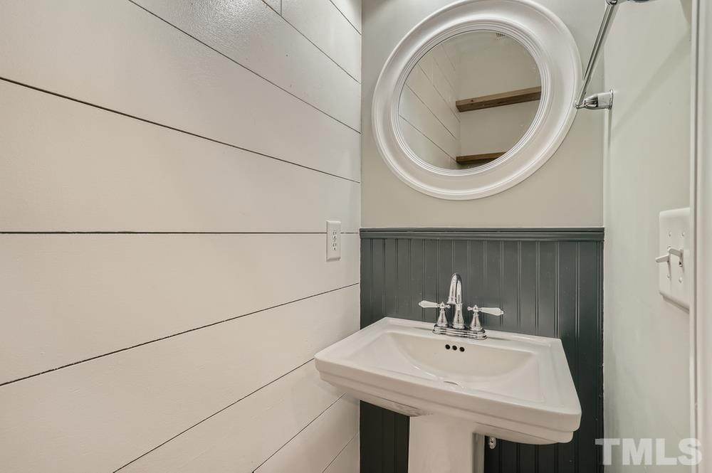 7012 Racine Way Raleigh, NC 27690 - Photo 14 of 28 a bathroom with a sink and a mirror