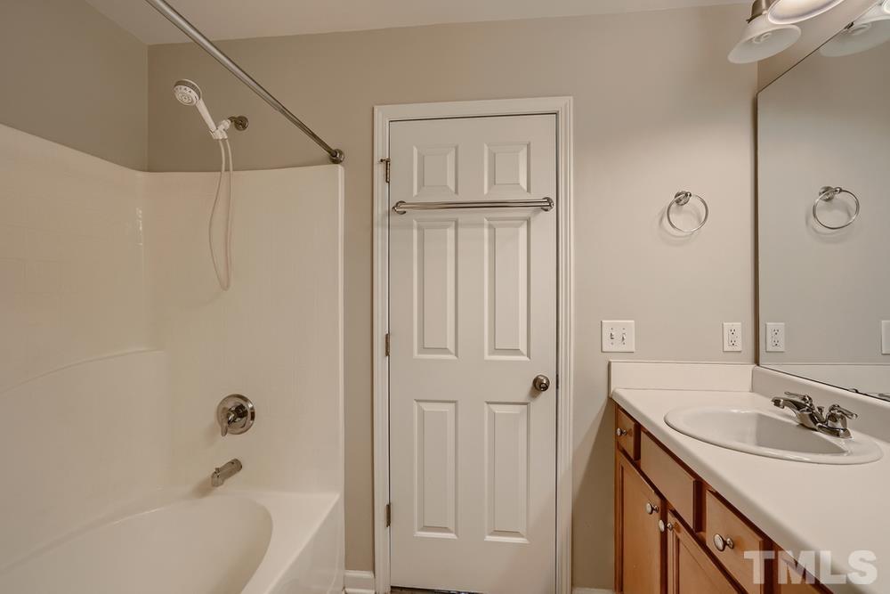 7012 Racine Way Raleigh, NC 27690 - Photo 18 of 28 a bathroom with a tub sink vanity granite and shower