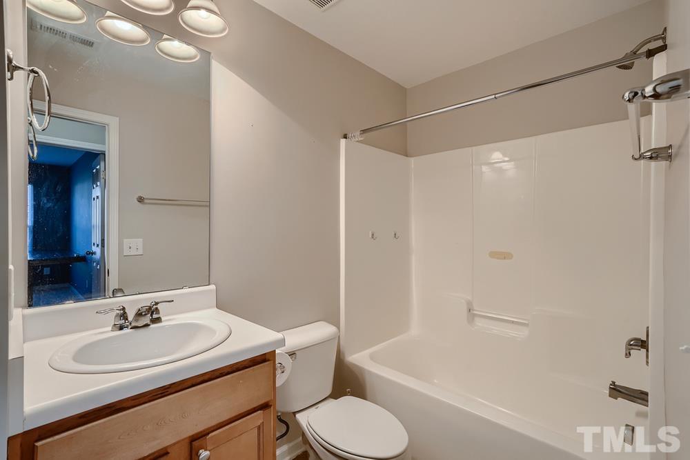 7012 Racine Way Raleigh, NC 27690 - Photo 23 of 28 a bathroom with a sink toilet and shower