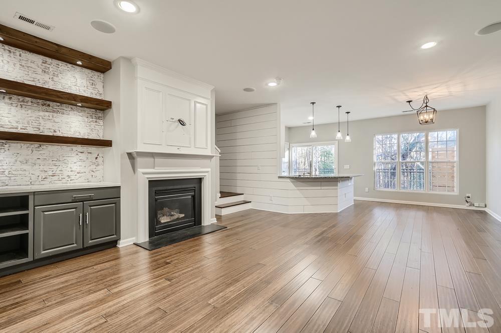 7012 Racine Way Raleigh, NC 27690 - Photo 5 of 28 a view of a kitchen with furniture and a fireplace