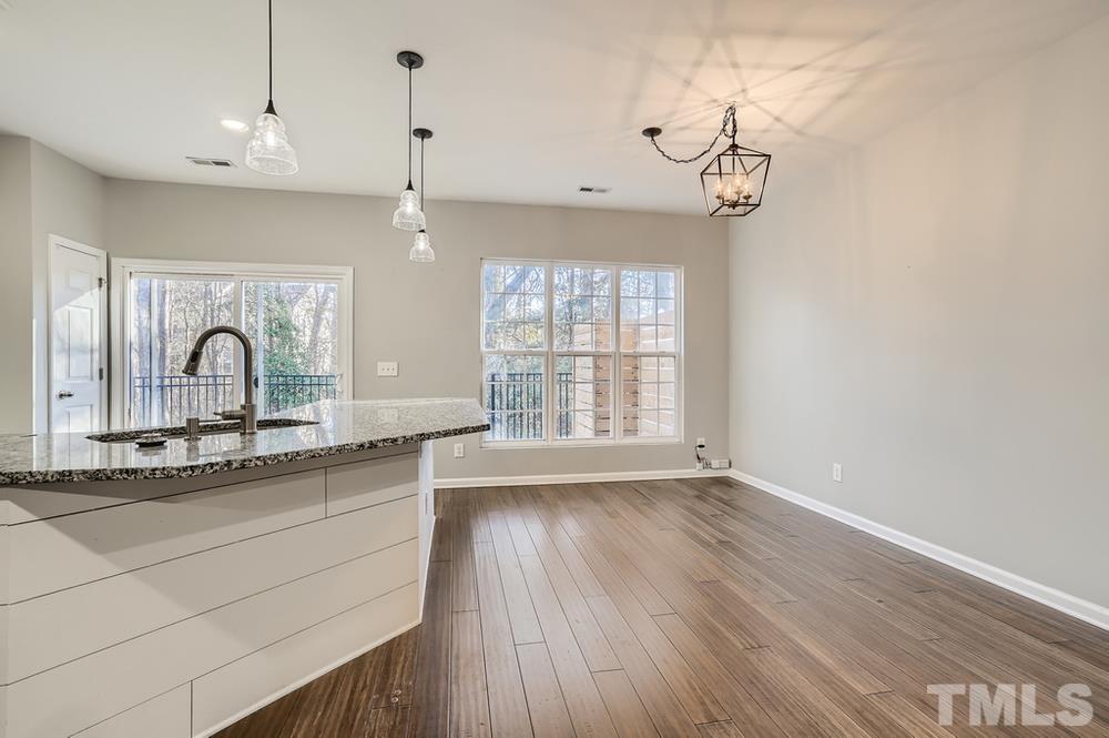 7012 Racine Way Raleigh, NC 27690 - Photo 8 of 28 a view of a room with a chandelier
