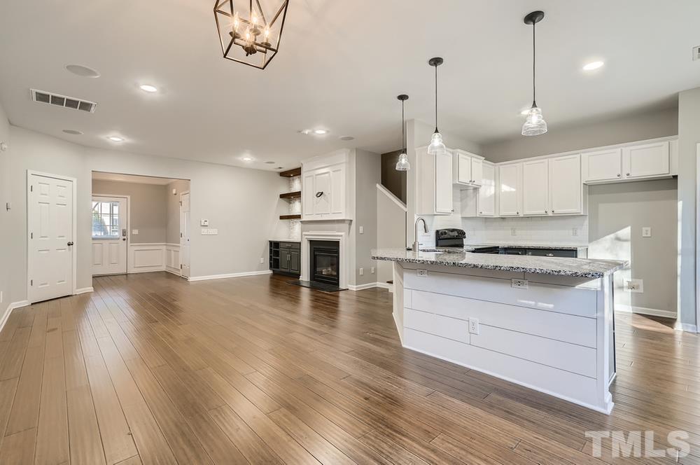 7012 Racine Way Raleigh, NC 27690 - Photo 10 of 28 a large kitchen with cabinets wooden floor and stainless steel appliances