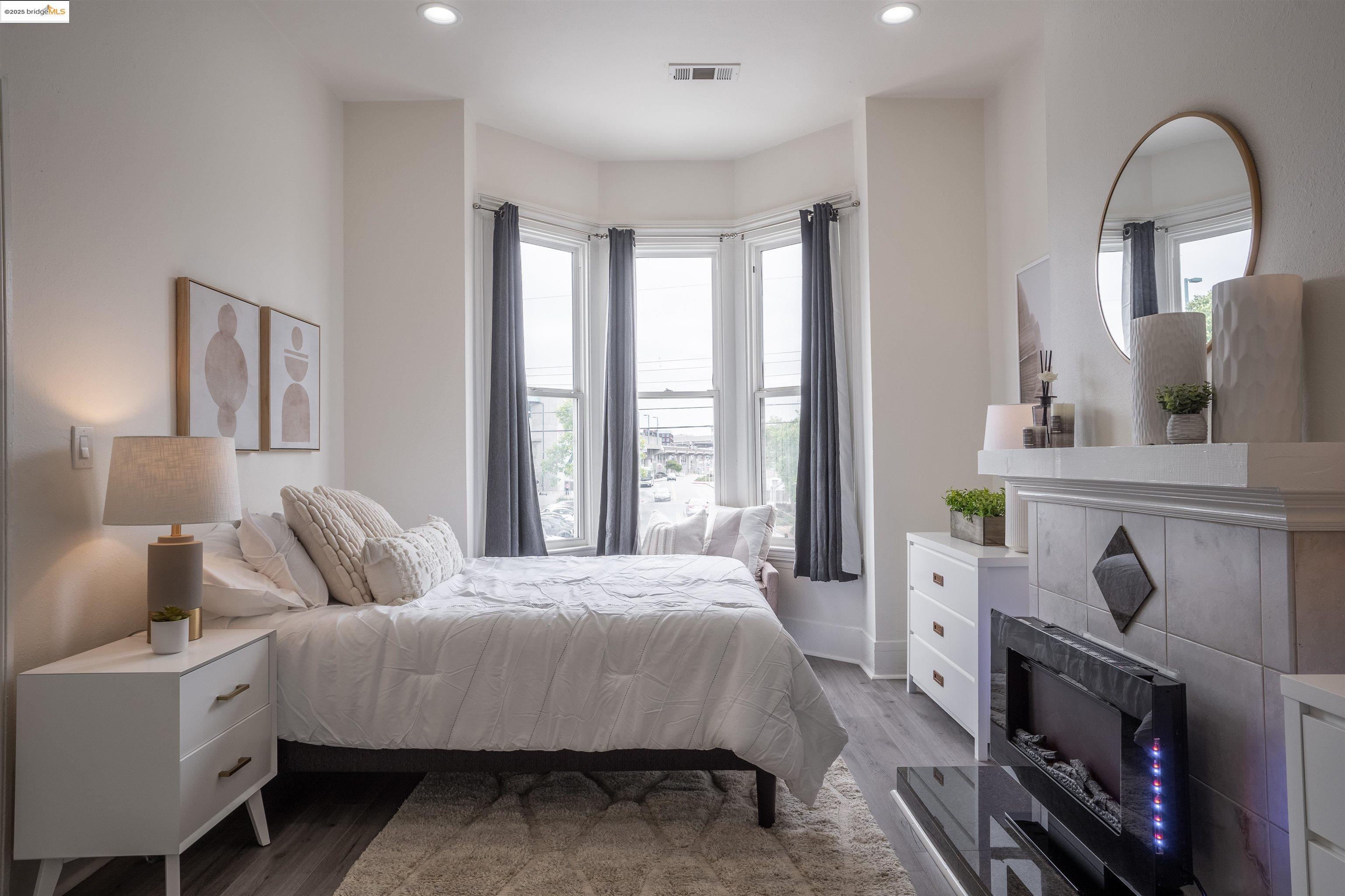 527 Chester Street Oakland, CA 94607 - Photo 37 of 59 Bedroom featuring multiple windows, light wood-style flooring, and recessed lighting