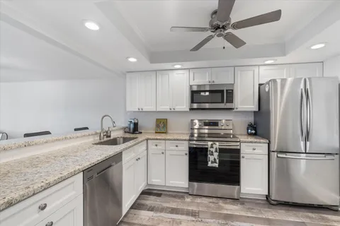 a kitchen with a sink stainless steel appliances and cabinets