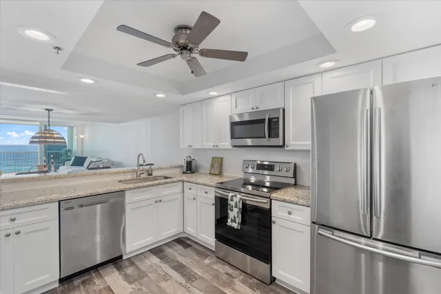 a bedroom with a large bed and a potted plant
