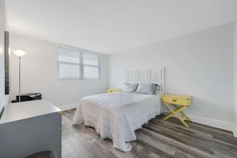 a bathroom with a granite countertop sink toilet and a mirror