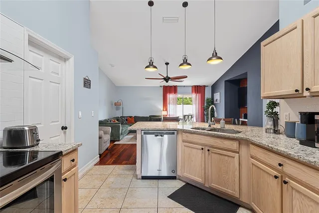 a kitchen with a sink counter top space appliances and cabinets