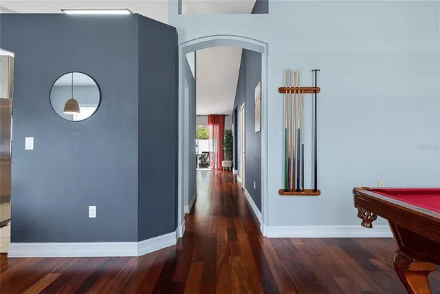 a view of a hallway with wooden floor and staircase