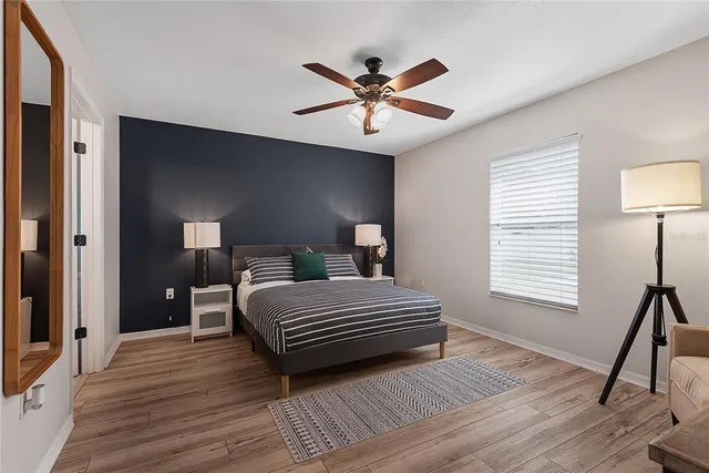 a bedroom with furniture and a flat screen tv