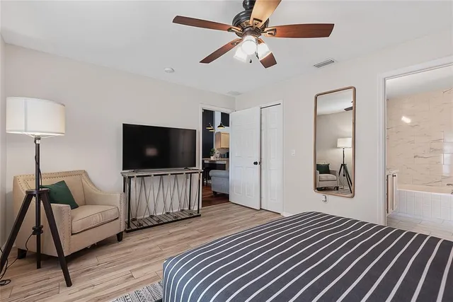 a bathroom with a granite countertop sink a mirror a bathtub and shower