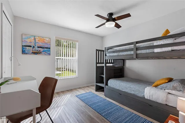 a bedroom with bunk bed and a chandelier