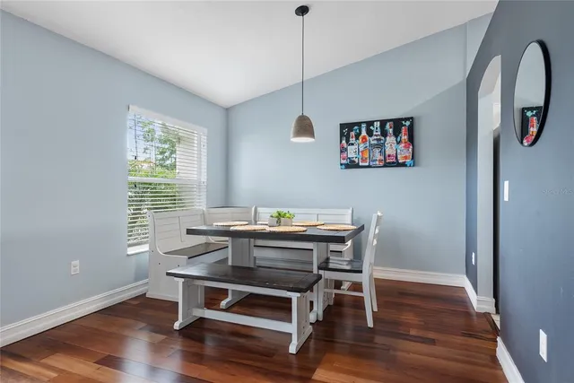 a view of a workspace with furniture window and wooden floor