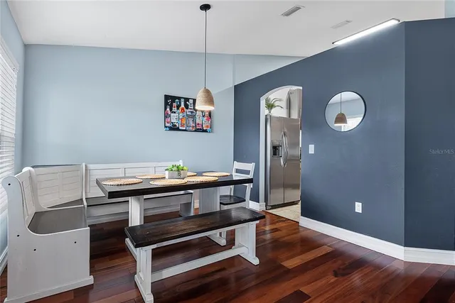 a work room with wooden floor and white walls