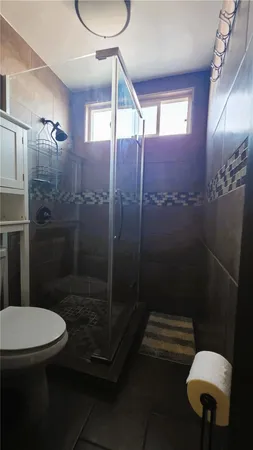 a bathroom with a toilet a sink and shower