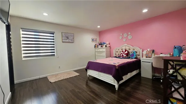 a bed room with a bed and a chair