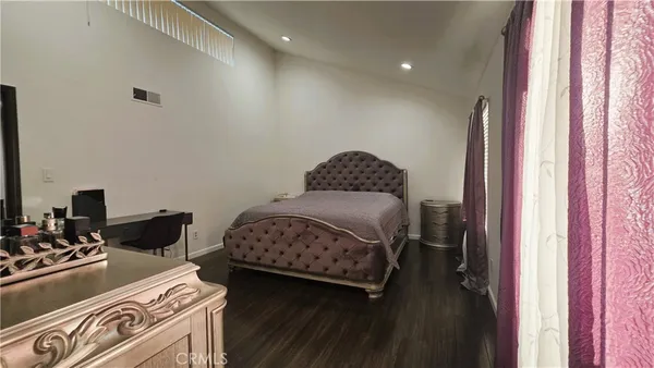 a bedroom with two beds and a dresser