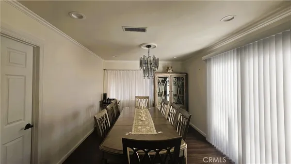 a view of a dining room with furniture and window