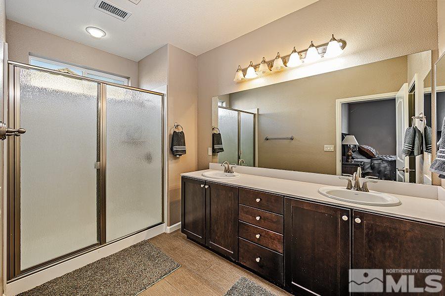2201 Dominic Drive Reno, NV 89521 - Photo 11 of 20 a bathroom with a double vanity sink and mirror
