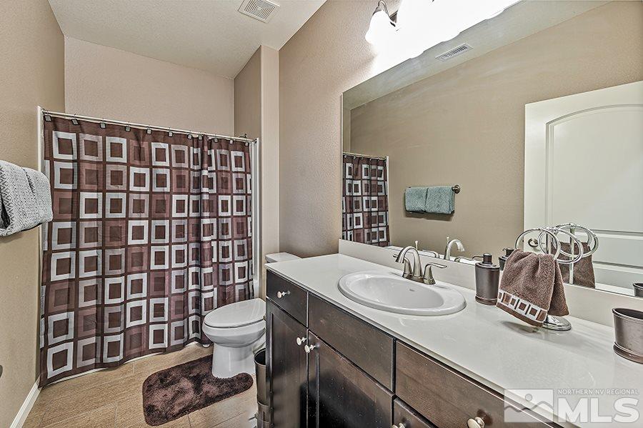 2201 Dominic Drive Reno, NV 89521 - Photo 14 of 20 a bathroom with a sink a toilet and shower