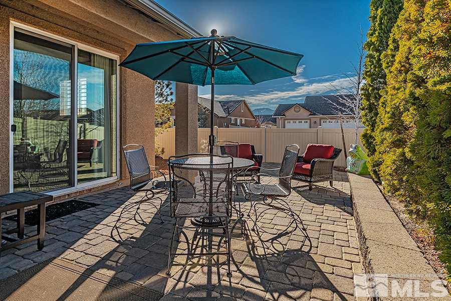 2201 Dominic Drive Reno, NV 89521 - Photo 17 of 20 a view of a patio with a table and chairs under an umbrella