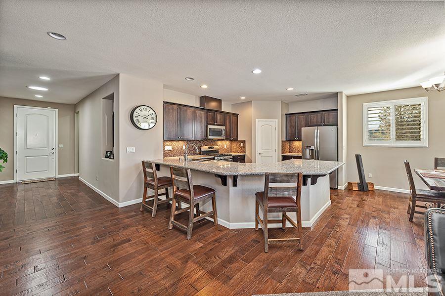 2201 Dominic Drive Reno, NV 89521 - Photo 5 of 20 a living room with stainless steel appliances kitchen island granite countertop furniture and wooden floor
